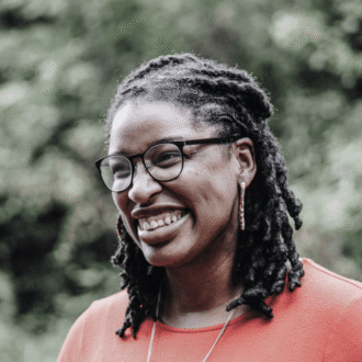 Smiling bespectacled women in an outdoor setting