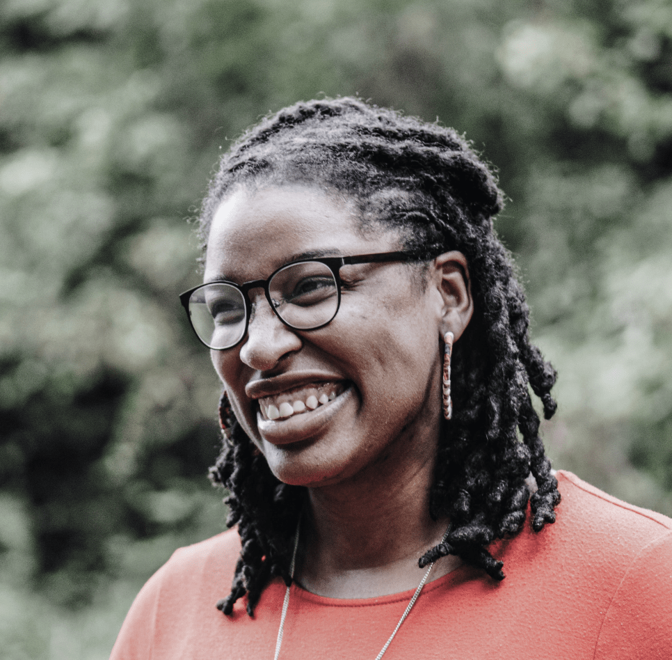 Smiling bespectacled women in an outdoor setting