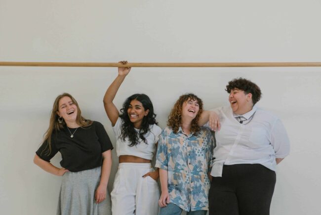 Four diverse survivors sharing a laugh