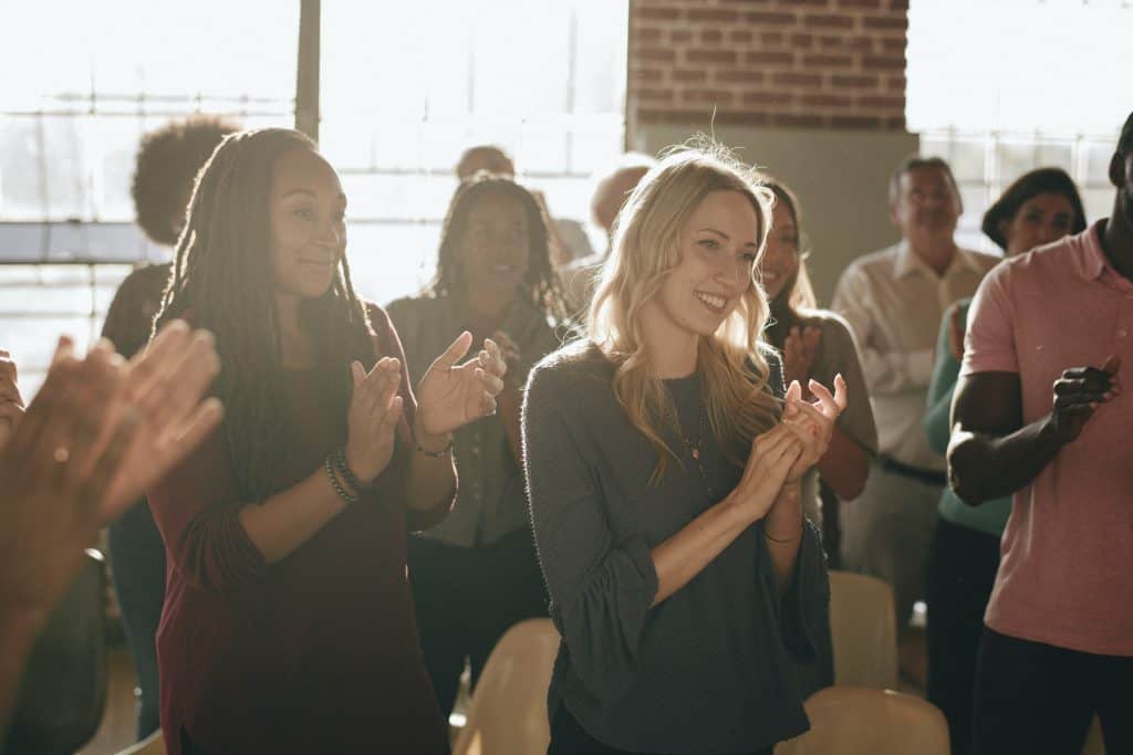 Diverse group of workshop attendants clapping