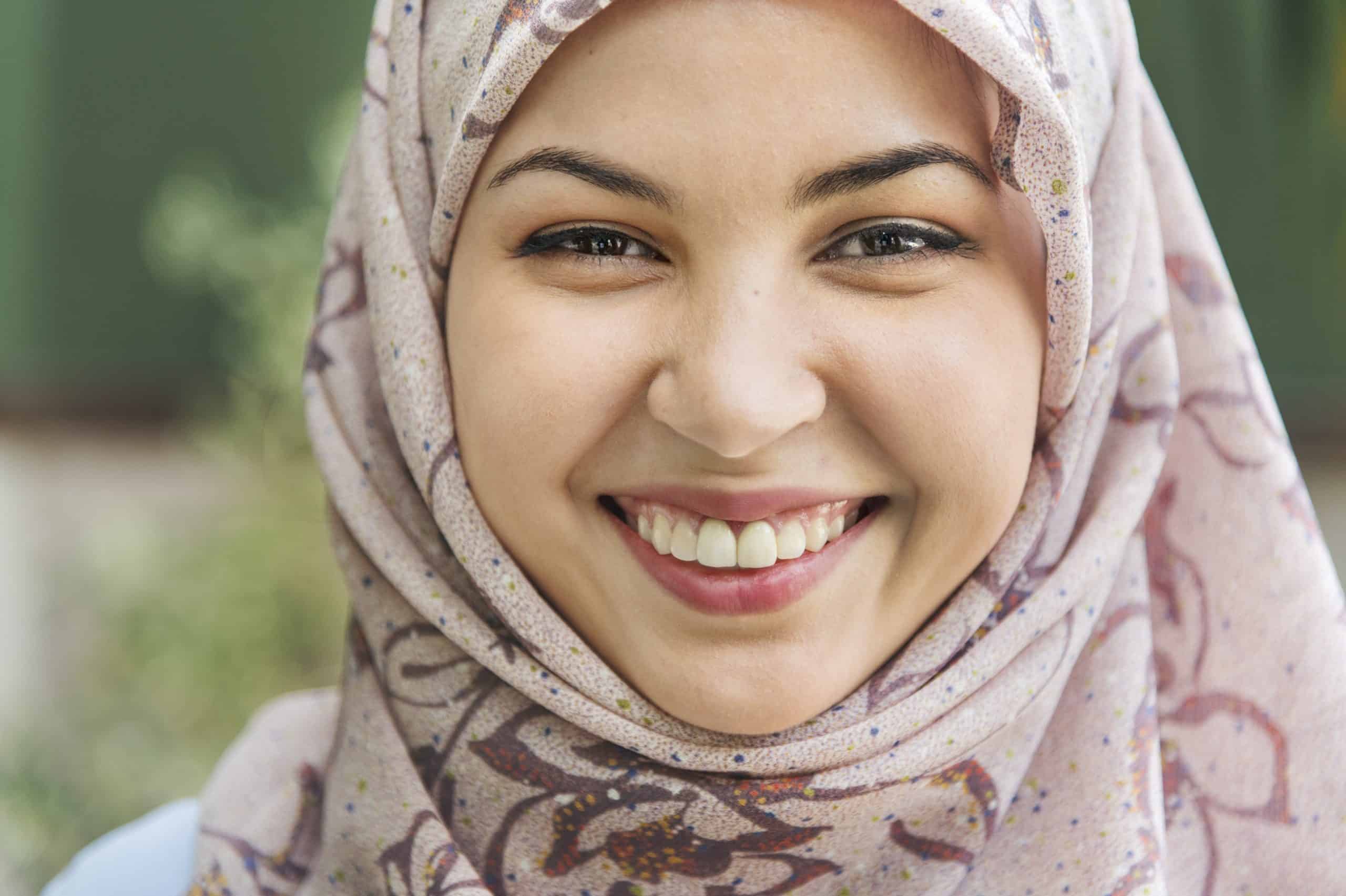 Smiling woman wearing a headscarf.