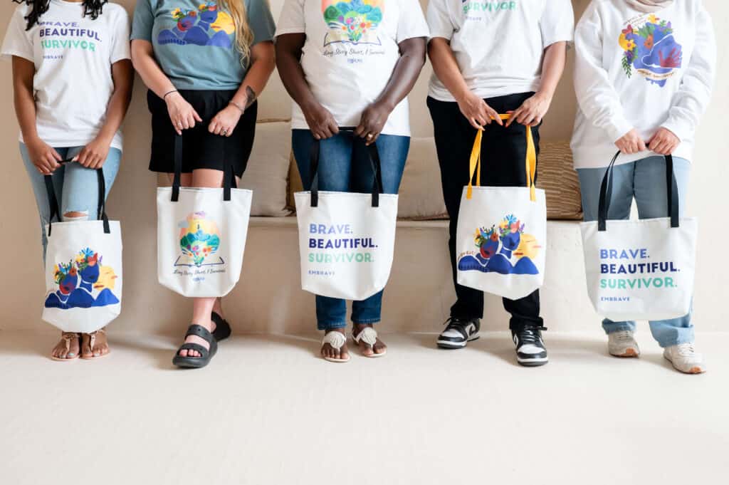 Group of women holding Embrave swag