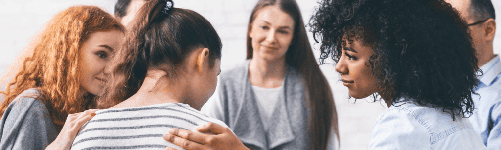 Diverse group of women supporting each other through trauma